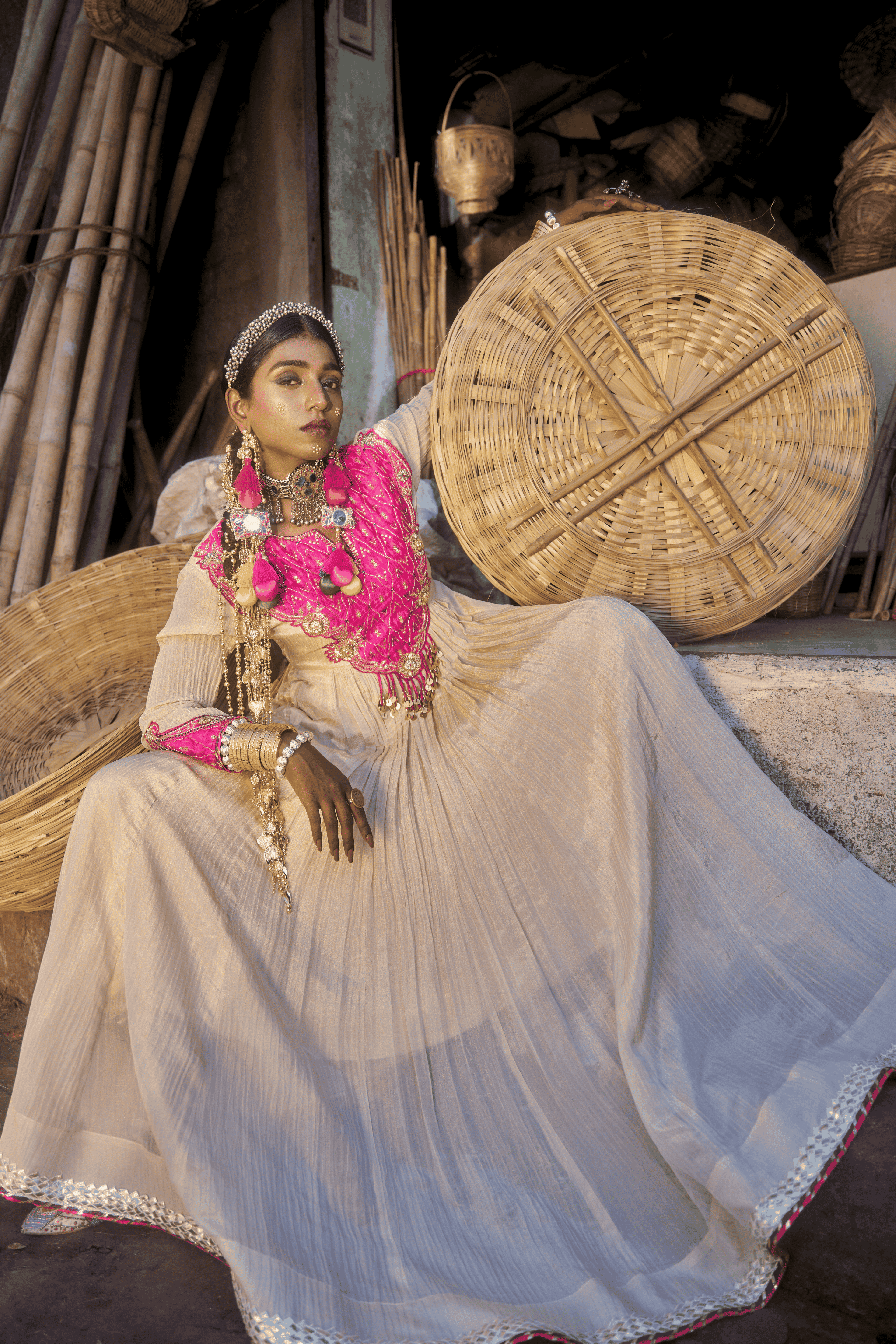 Woman in traditional attire with a large woven basket in an outdoor setting